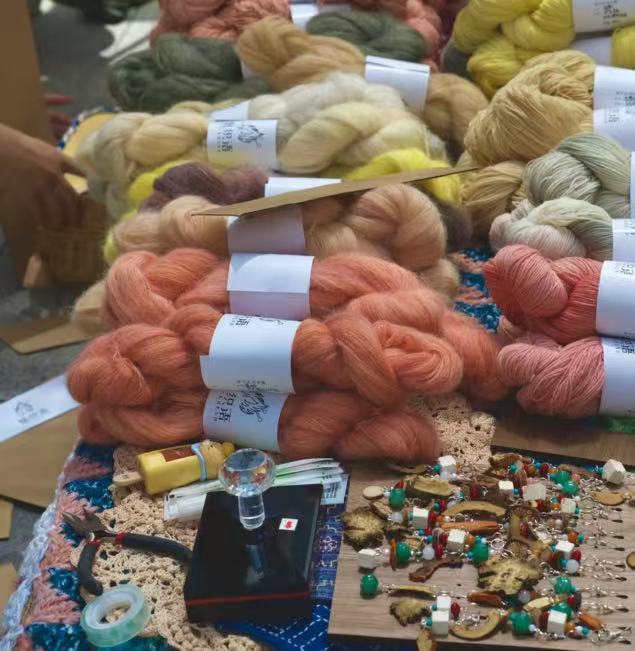 CheckMend herbal-dyed yarn and stitch markers at the Shanghai market